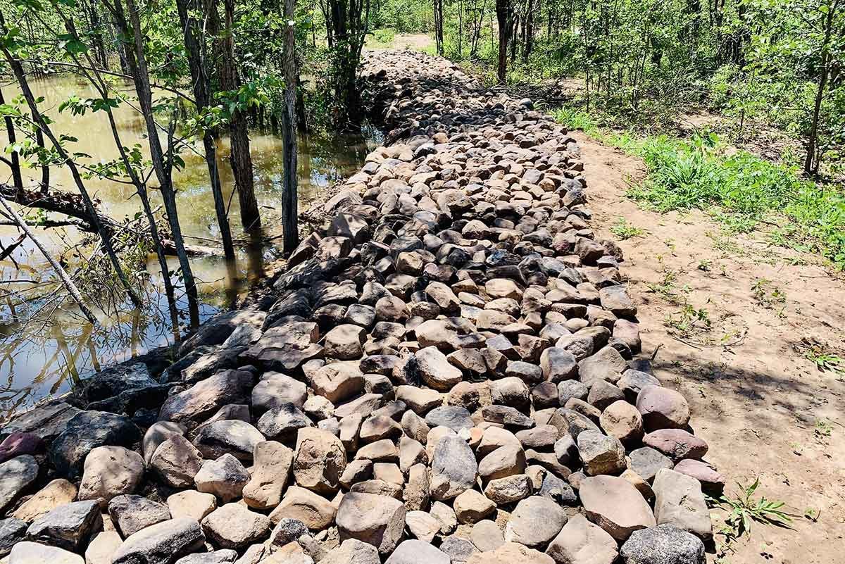 Stone wildlife barrier and water management infrastructure in Mucheni